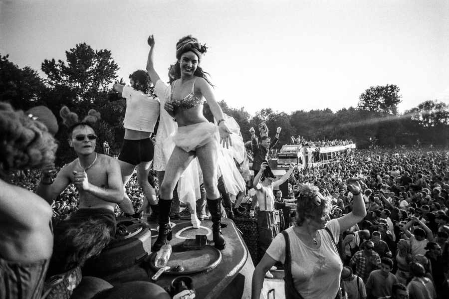 Love Parade Berlin — black and white photo of a woman dancing on top of a parade truck above a massive crowd